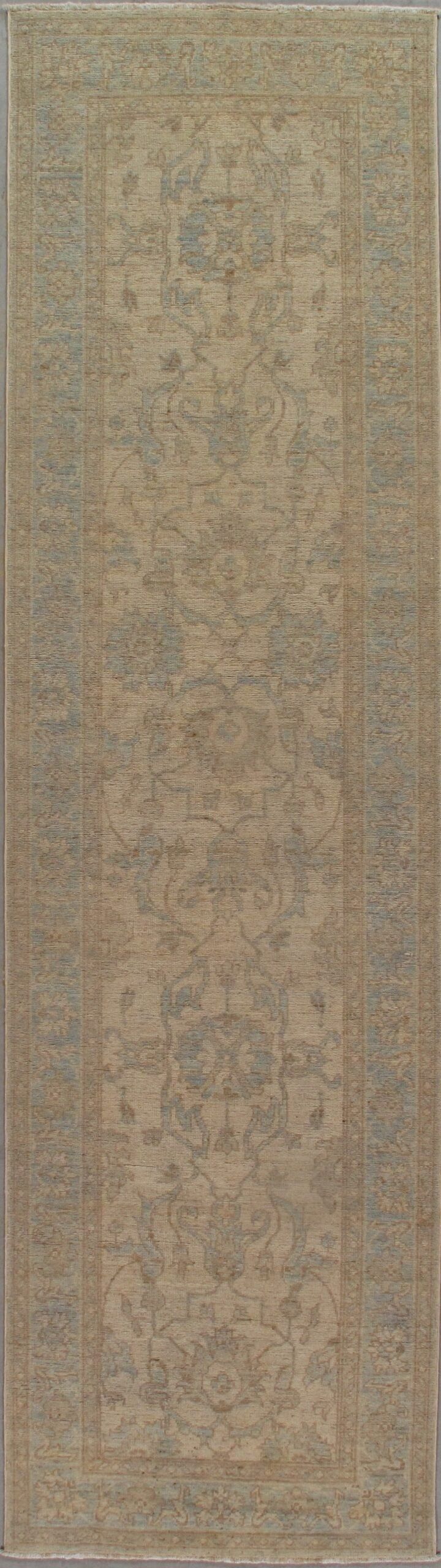 A close up of a beige rug on a white surface.