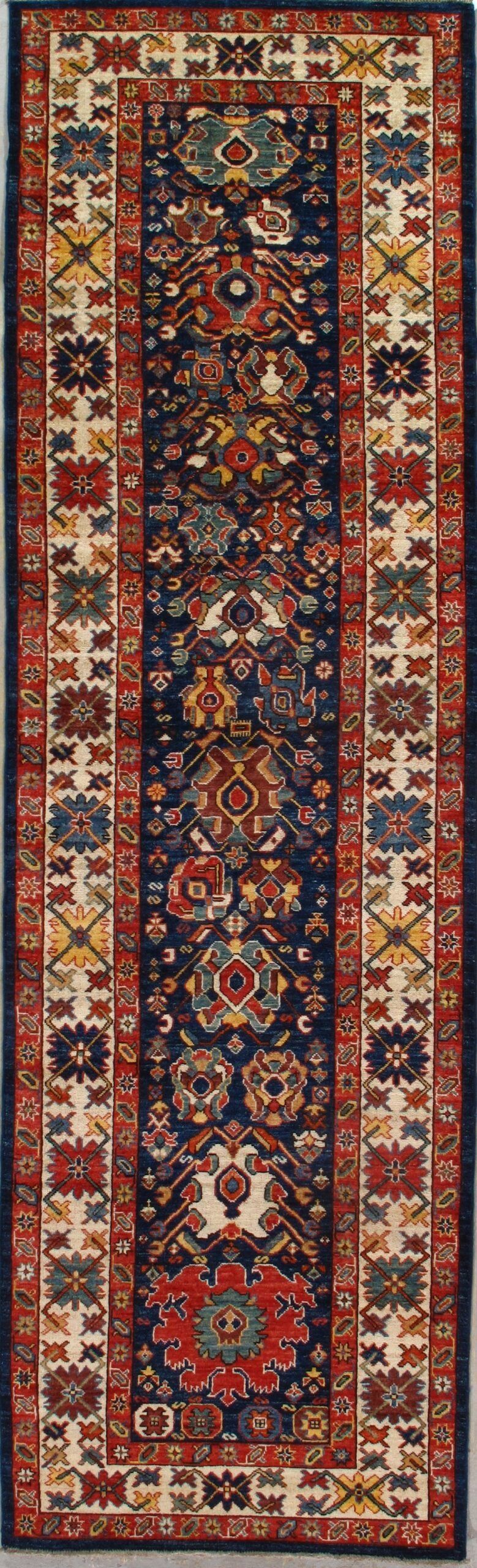 A long rug with a floral pattern on it is hanging on a wall.