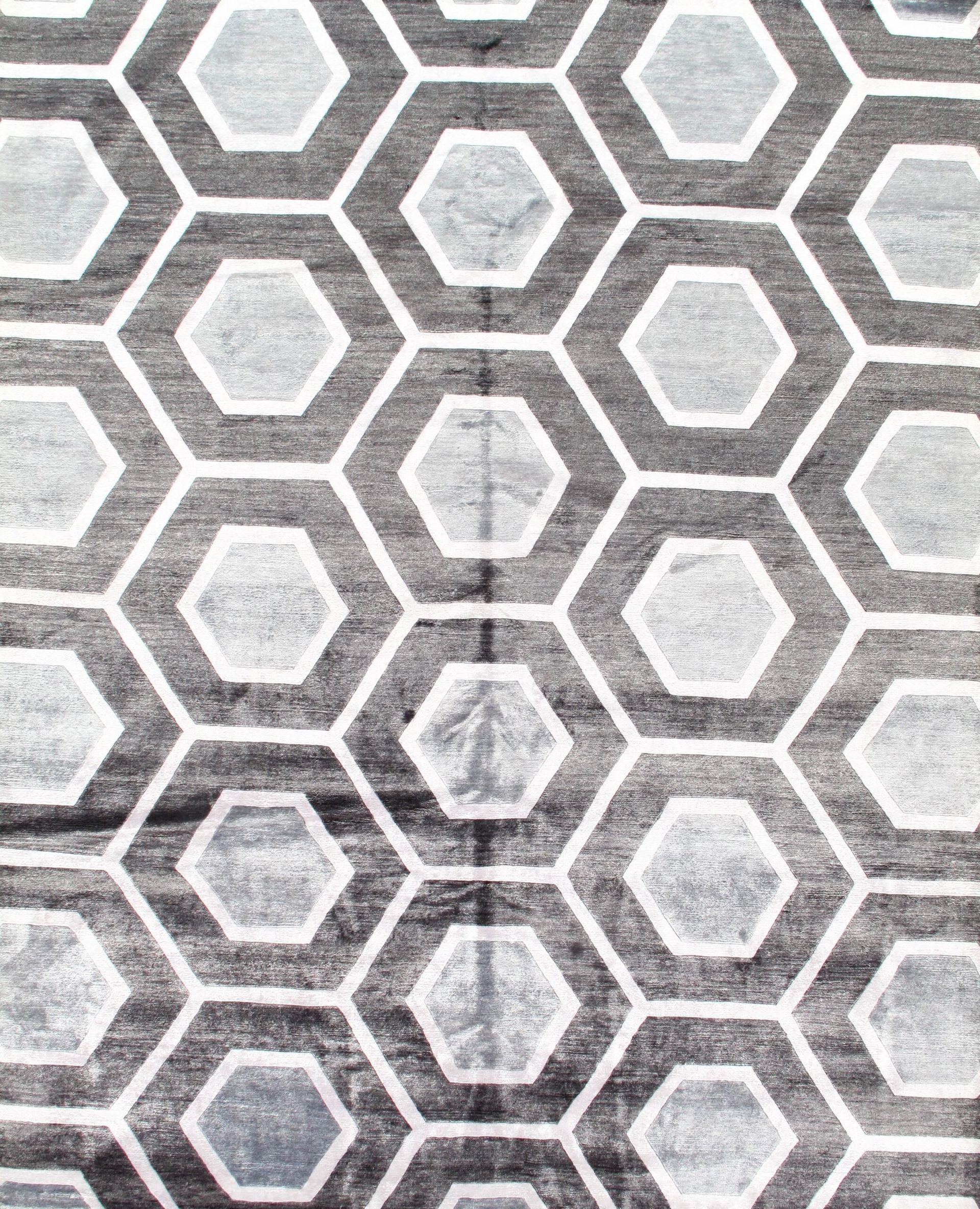 A black and white rug with a honeycomb pattern on it.