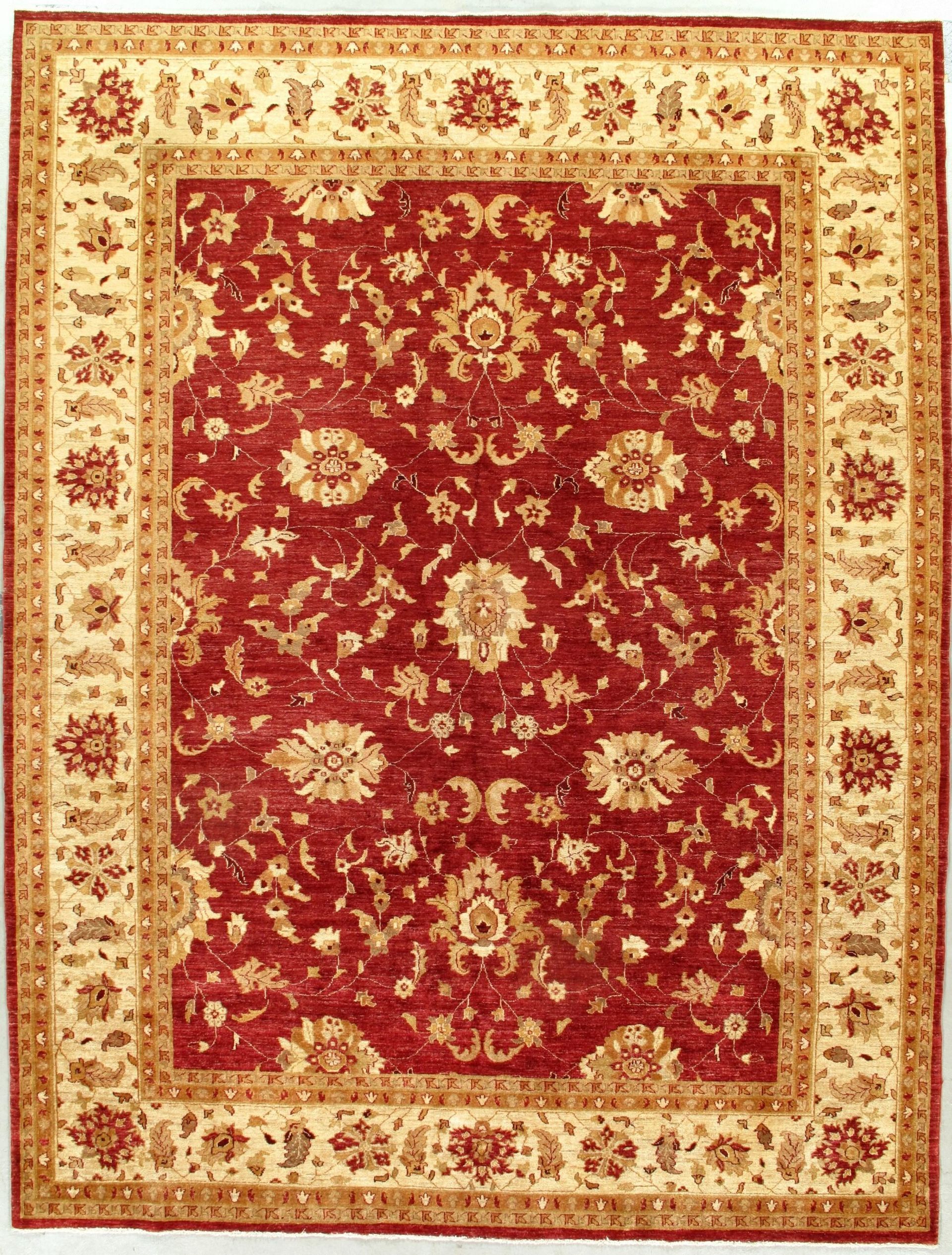 A red and gold rug with a floral pattern on it