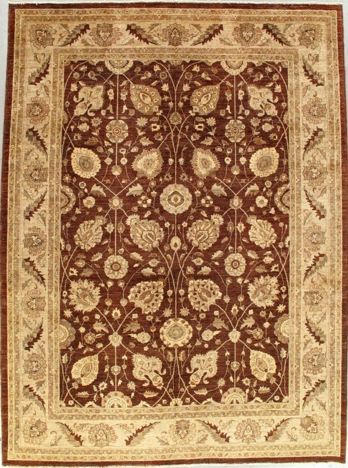 A brown and tan rug with a floral pattern on it