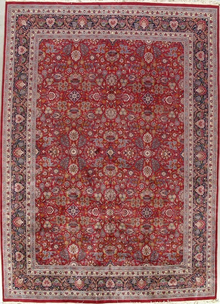 A red rug with a floral pattern on it is sitting on a table.