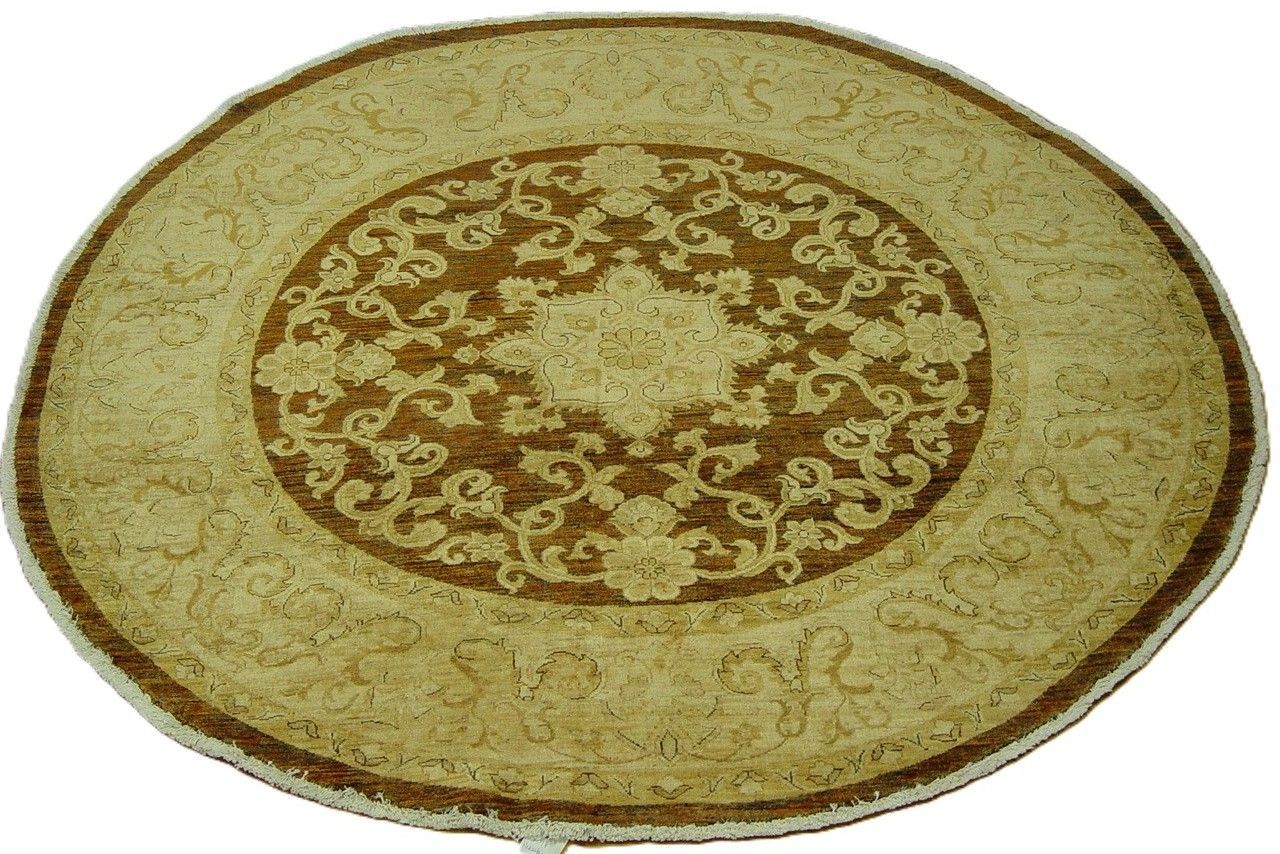 Round beige rug with brown floral center design.
