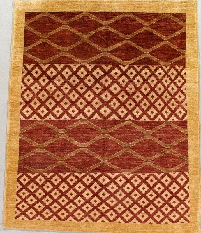 A rug with a red and gold pattern on it