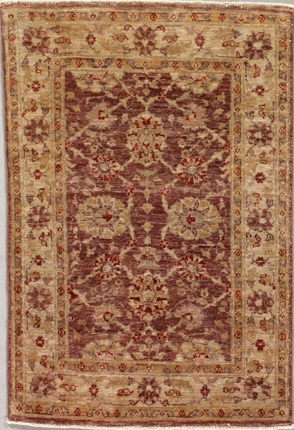 A rug with a floral pattern on it is hanging on a wall.
