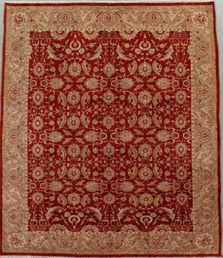 A red and gold rug with a floral pattern