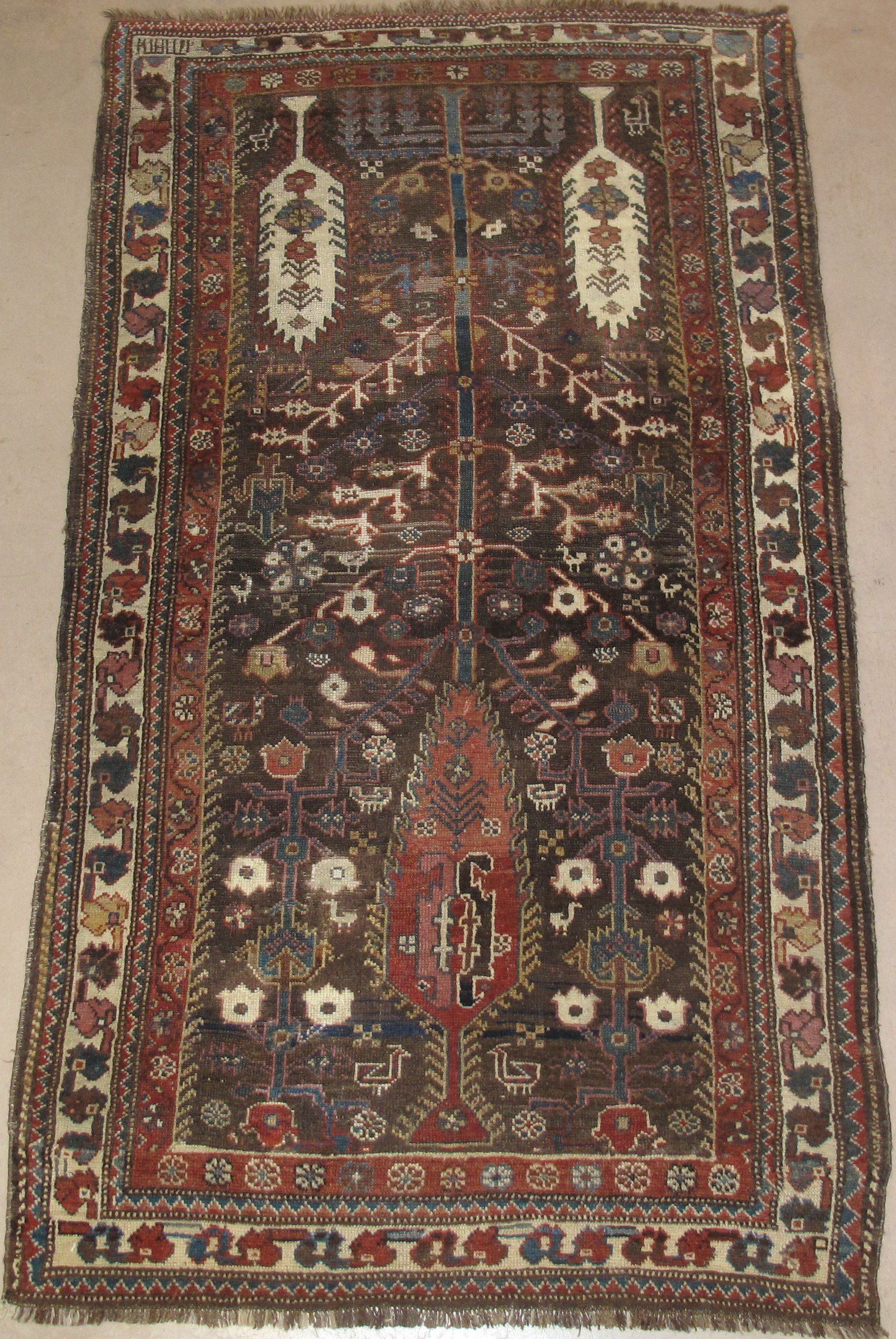 A rug with a tree and flowers on it