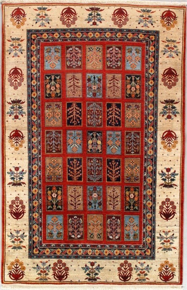 A rug with a pattern of squares and flowers on it