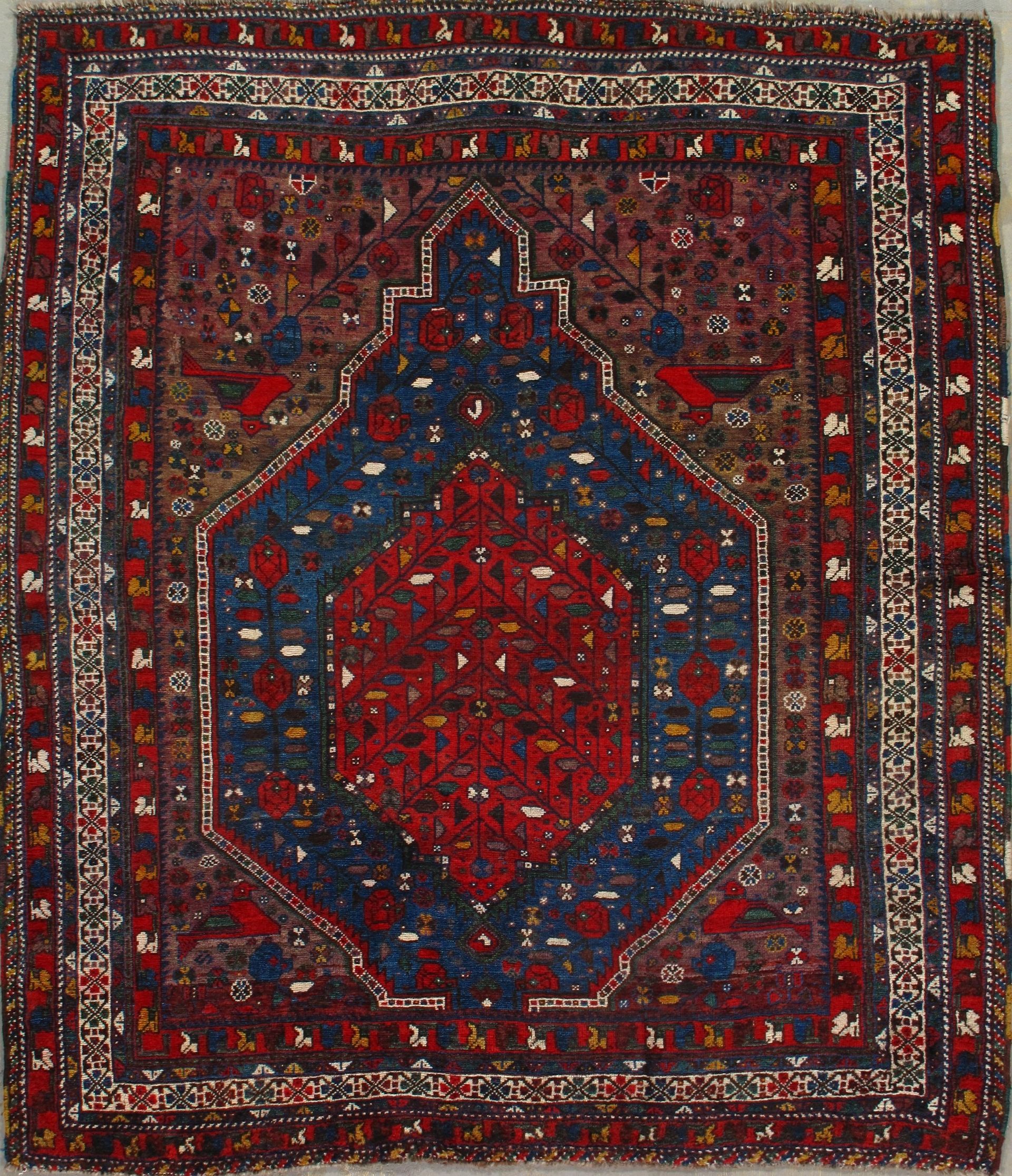 A rug with a red and blue pattern on it