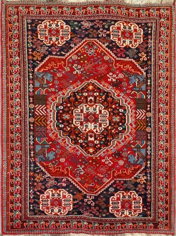 A red rug with a pattern on it is sitting on a table.