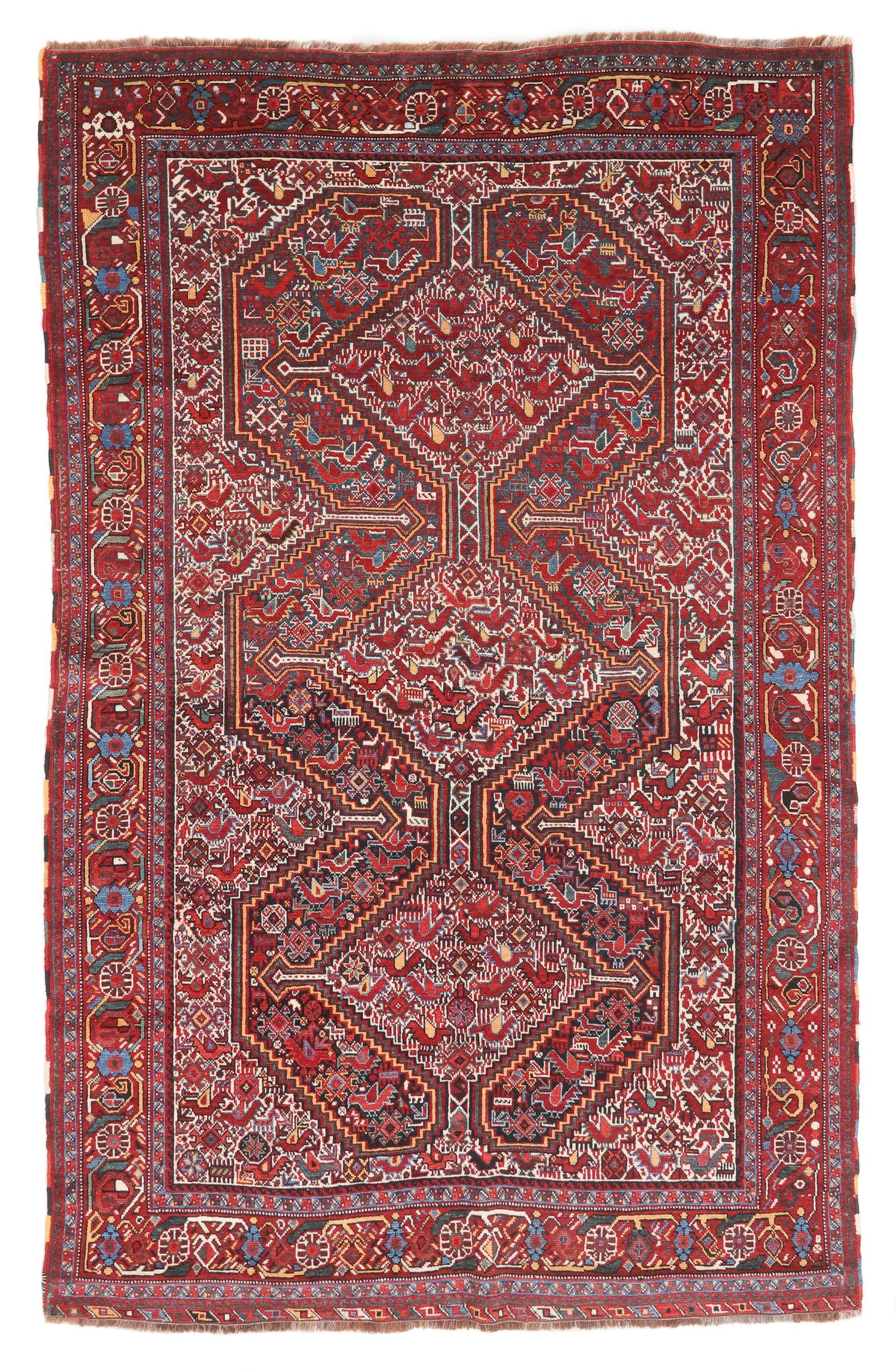 A red rug with a pattern on it is on a white background.