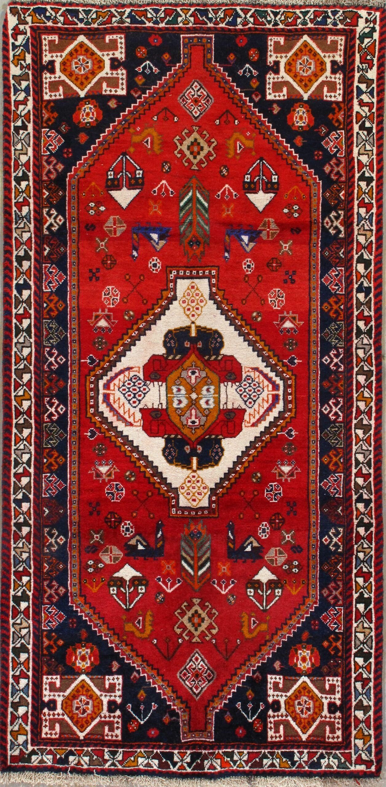A red rug with a diamond pattern on it