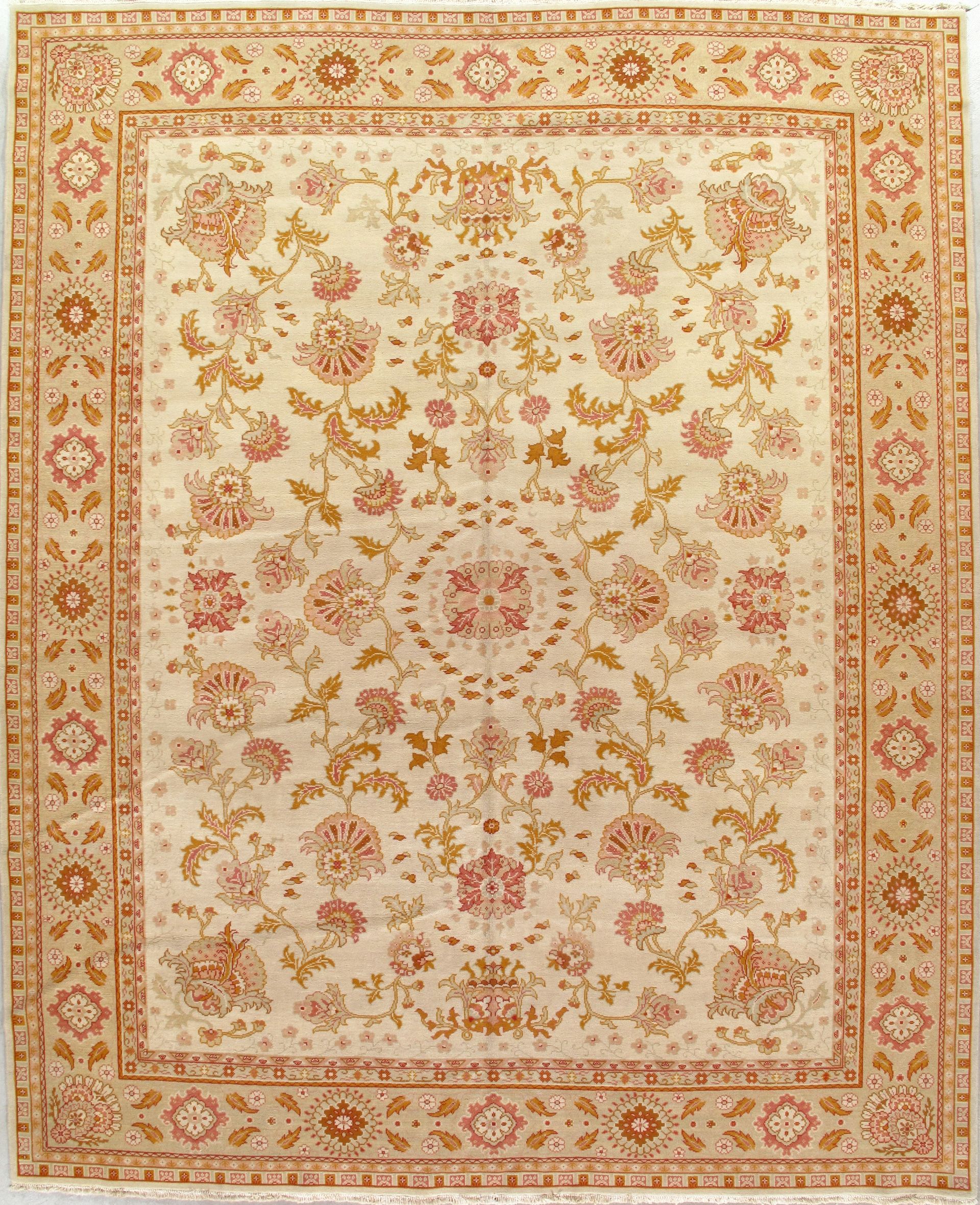 Ornate cream rug with pink and gold floral medallion pattern and decorative border