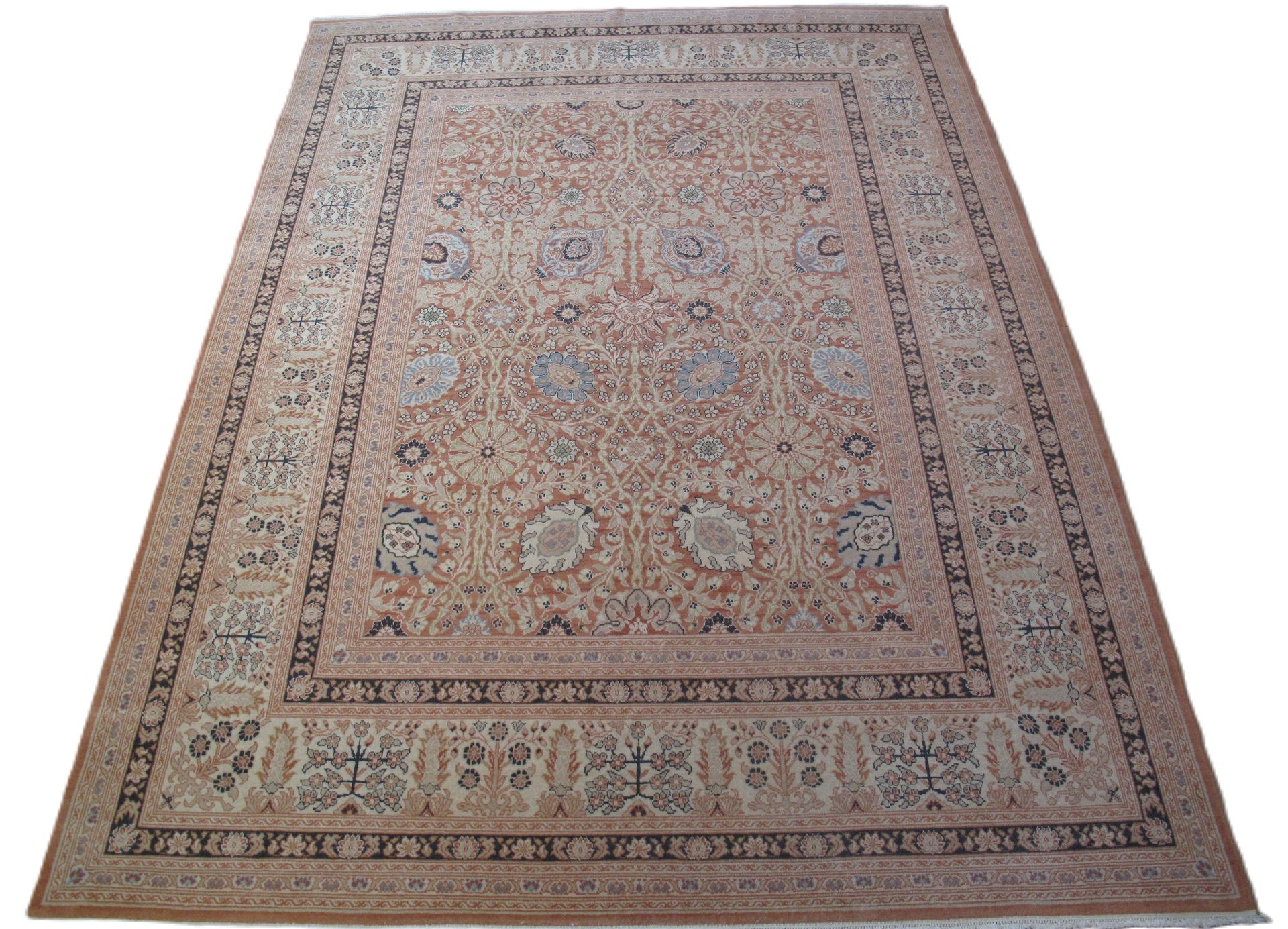 A rug with a floral pattern is laying on a white surface