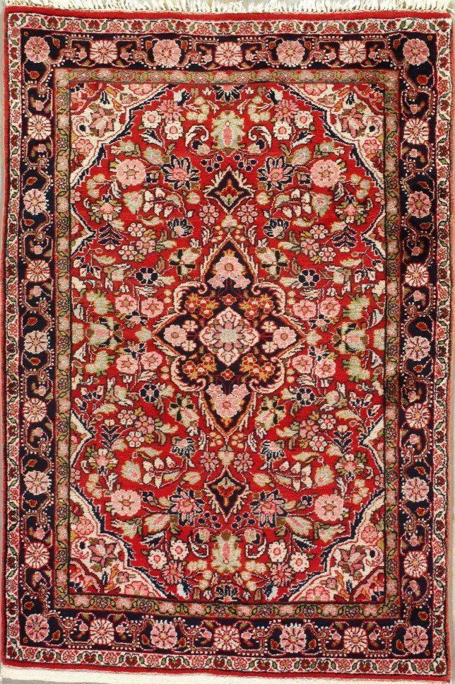 A red rug with a floral pattern on it.