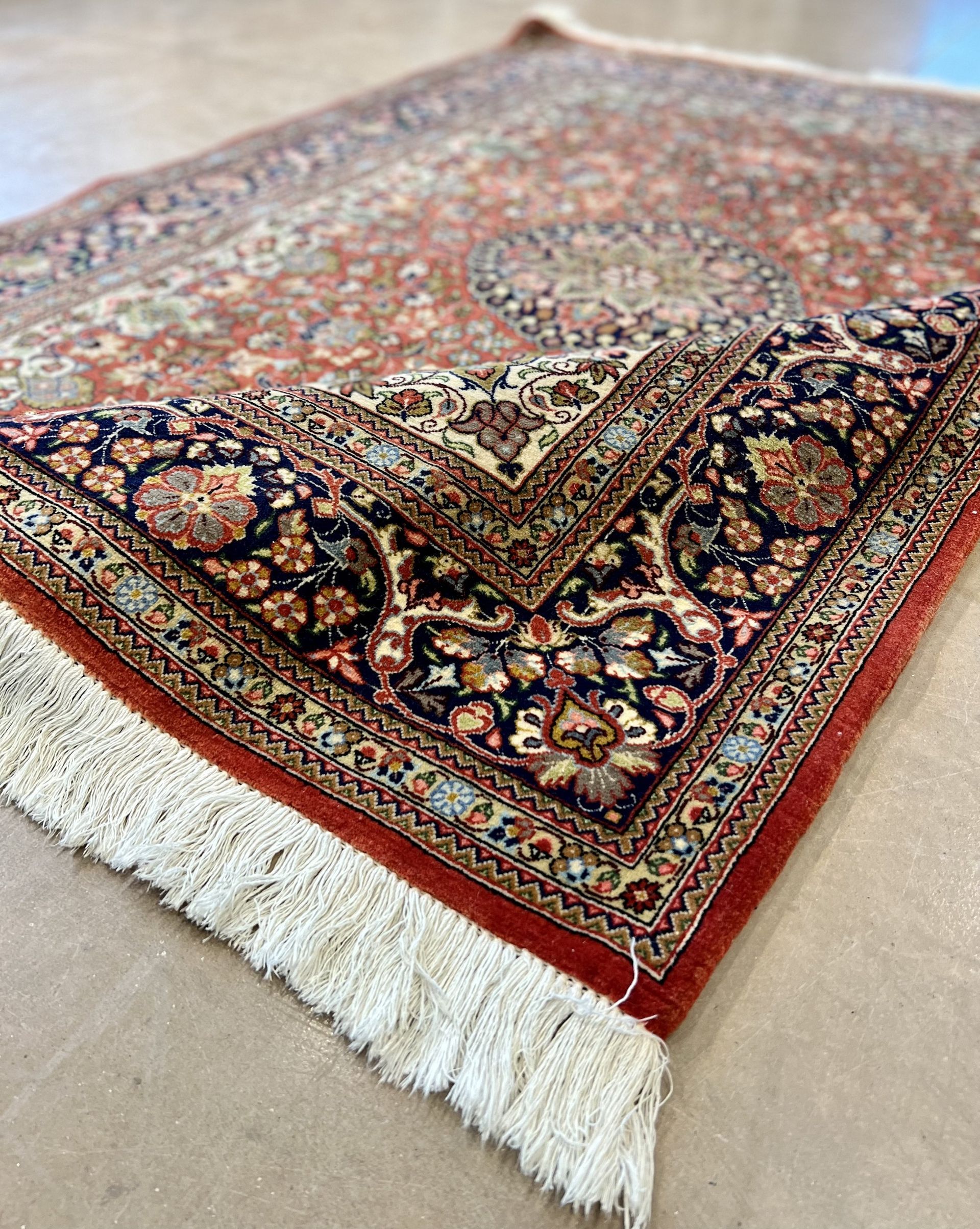 A close up of a rug with a floral pattern on it.