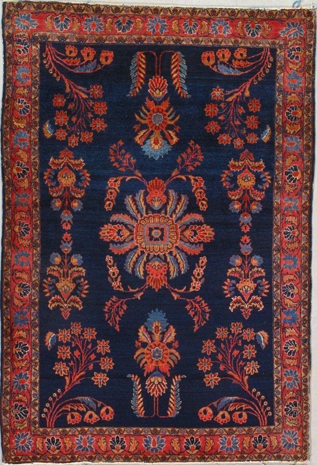 A blue rug with flowers and leaves on it