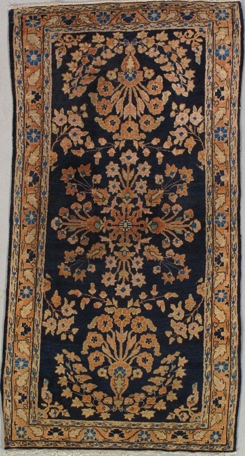 A rug with a floral pattern on it is hanging on a wall