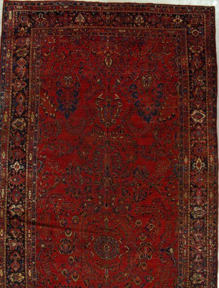 A red rug with a floral pattern on it