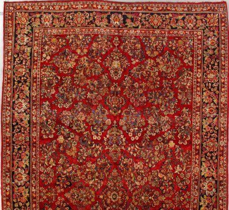 A red rug with a floral pattern on it
