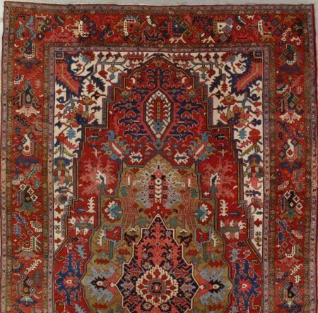 A red rug with a floral pattern and the word oasis on it