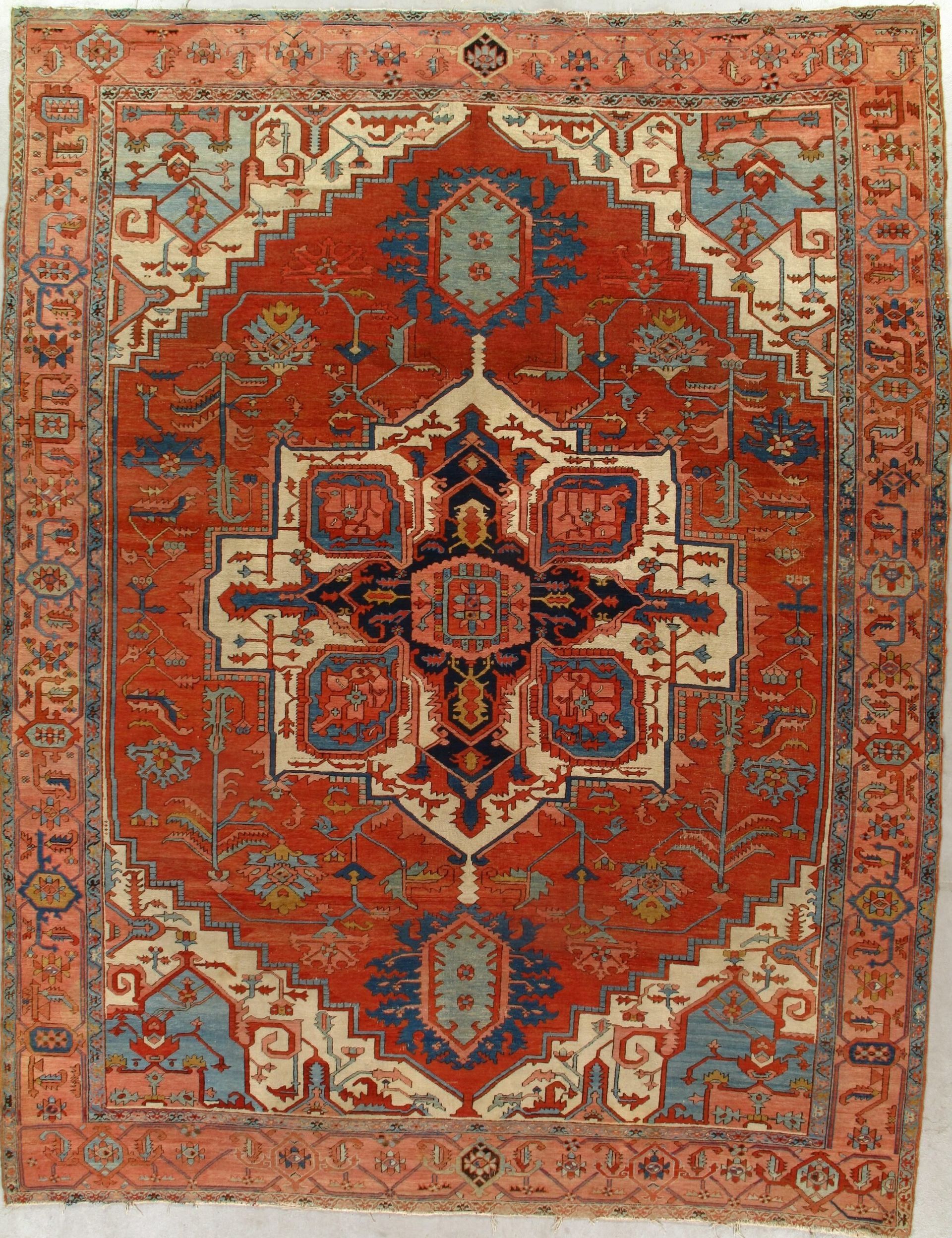 A red rug with a blue and white pattern on it