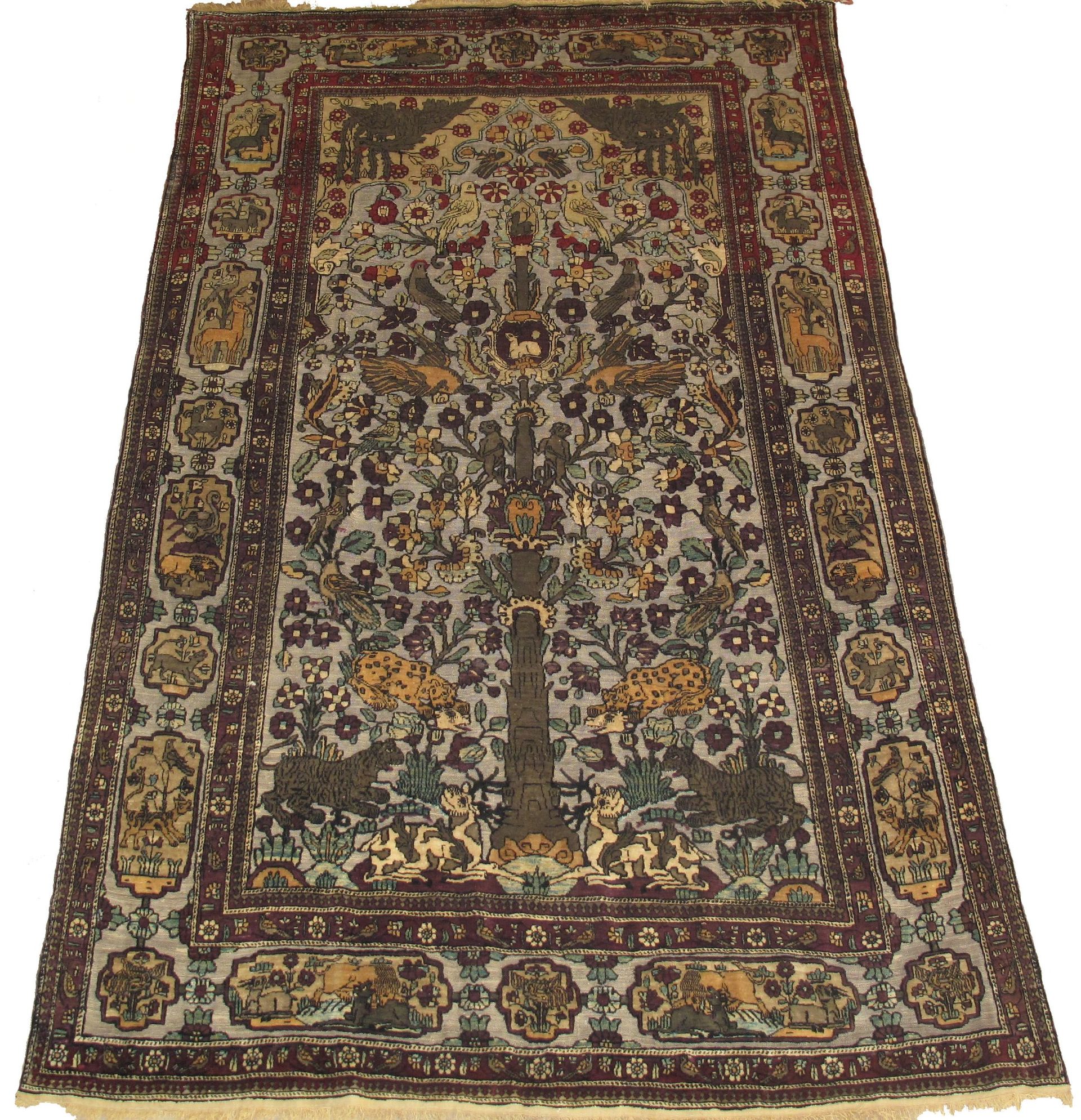 A rug with a floral pattern and elephants on it