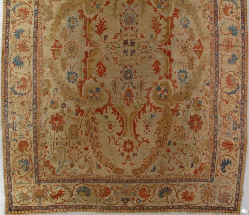 A rug with a floral pattern on it is hanging on a wall.