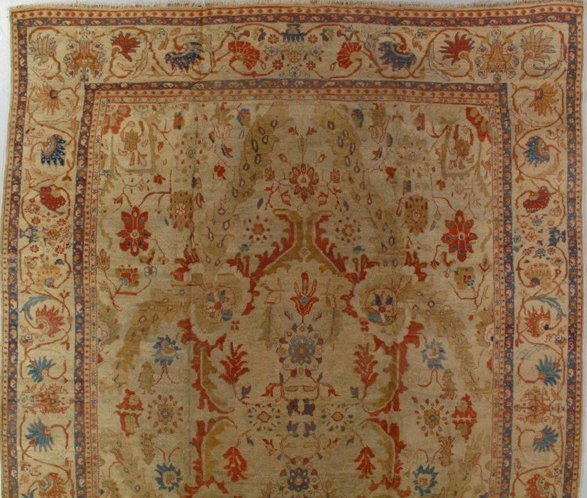 A rug with a floral pattern on it is hanging on a wall.