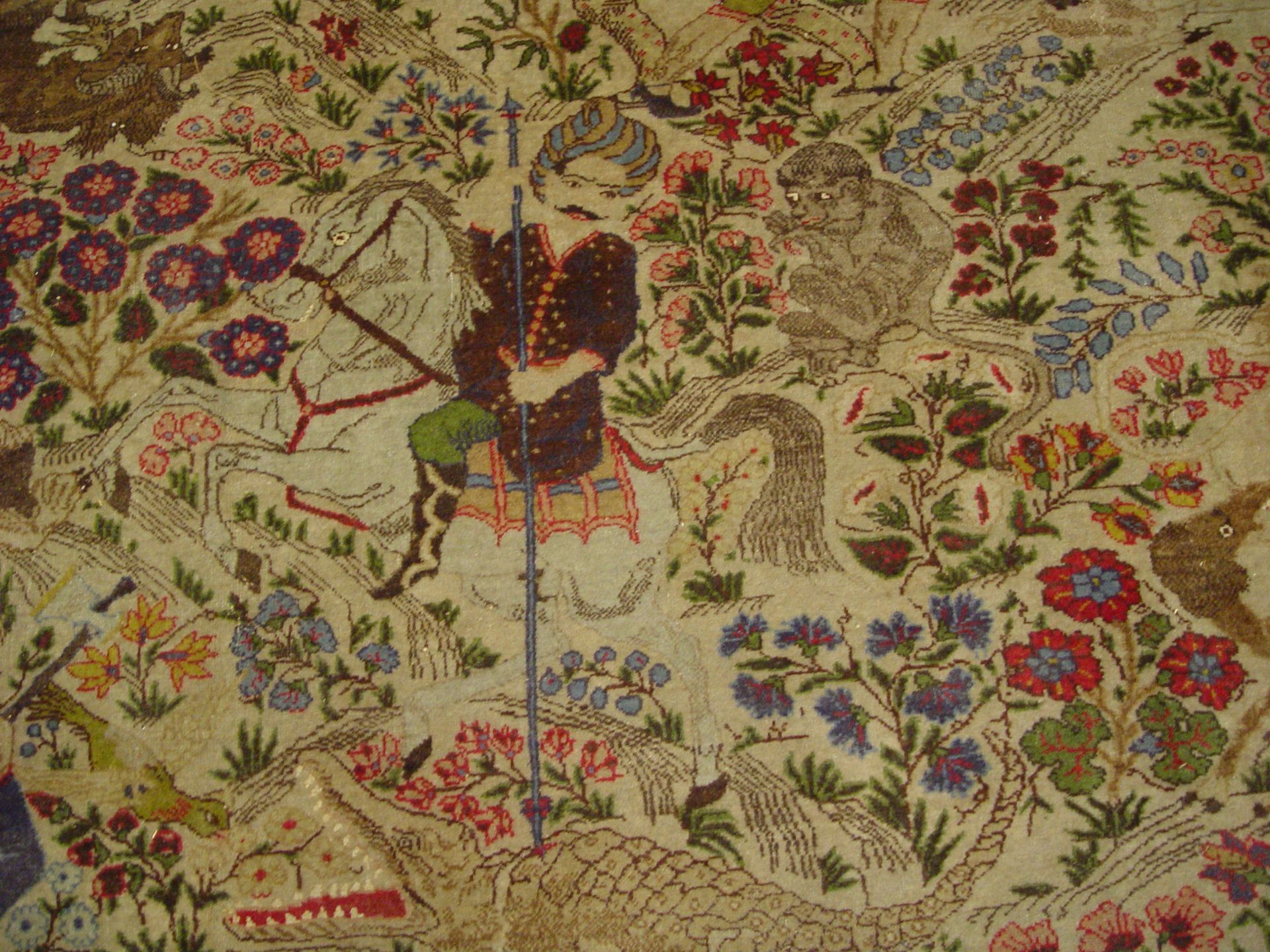 A rug with a floral pattern and animals on it