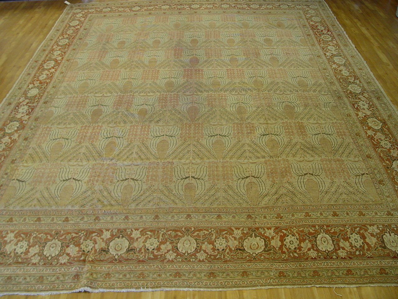 A rug with a pattern on it is hanging on a wall.