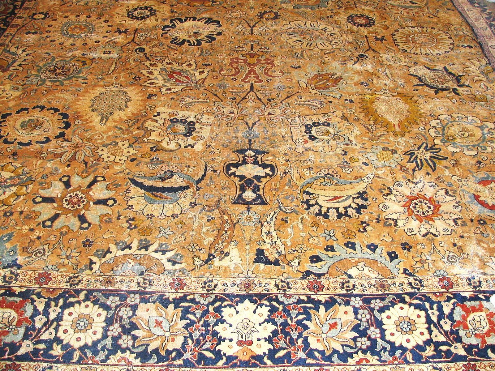 A close up of a rug with a floral pattern on a white background.