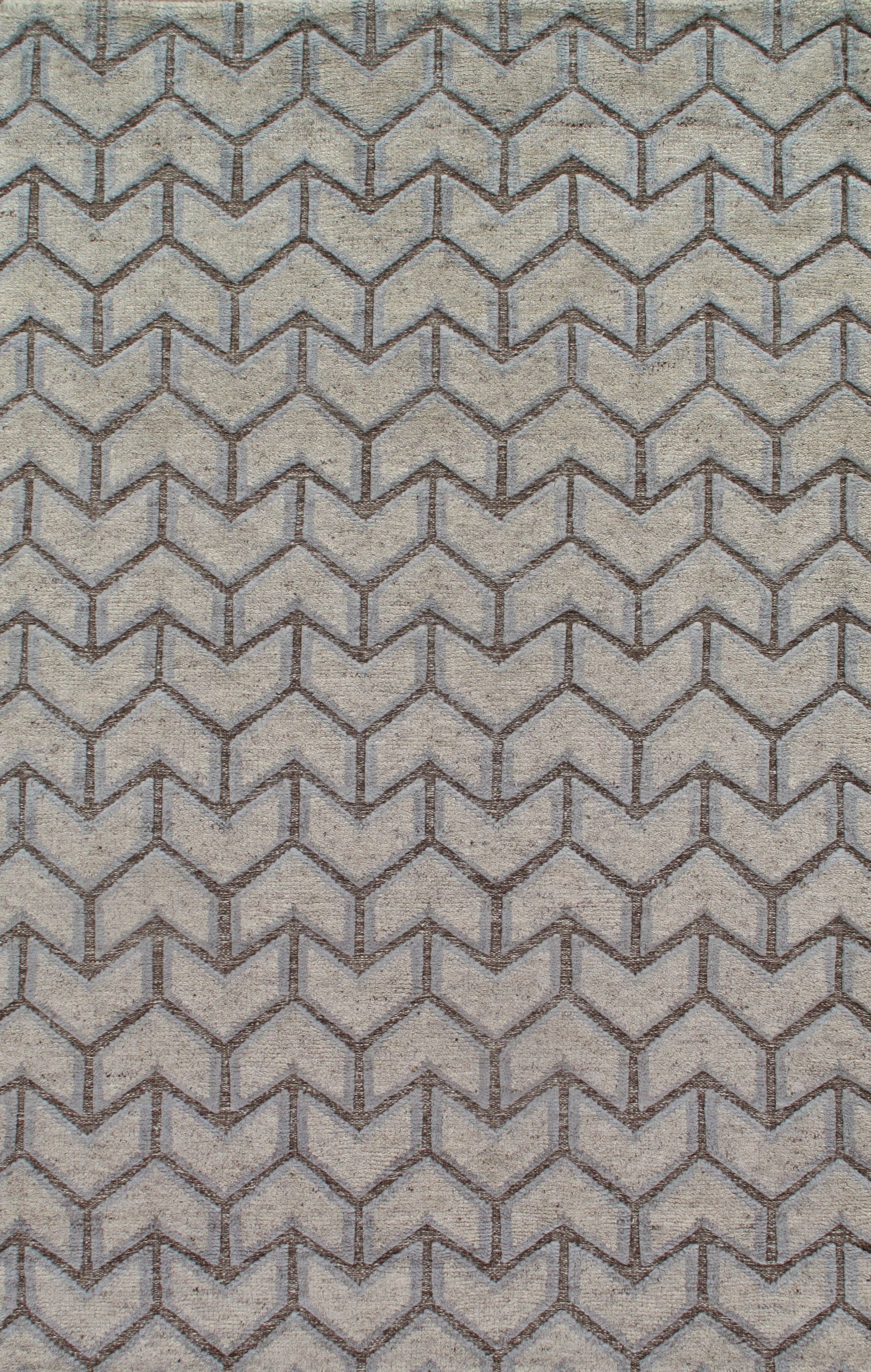 A close up of a rug with a chevron pattern on it.