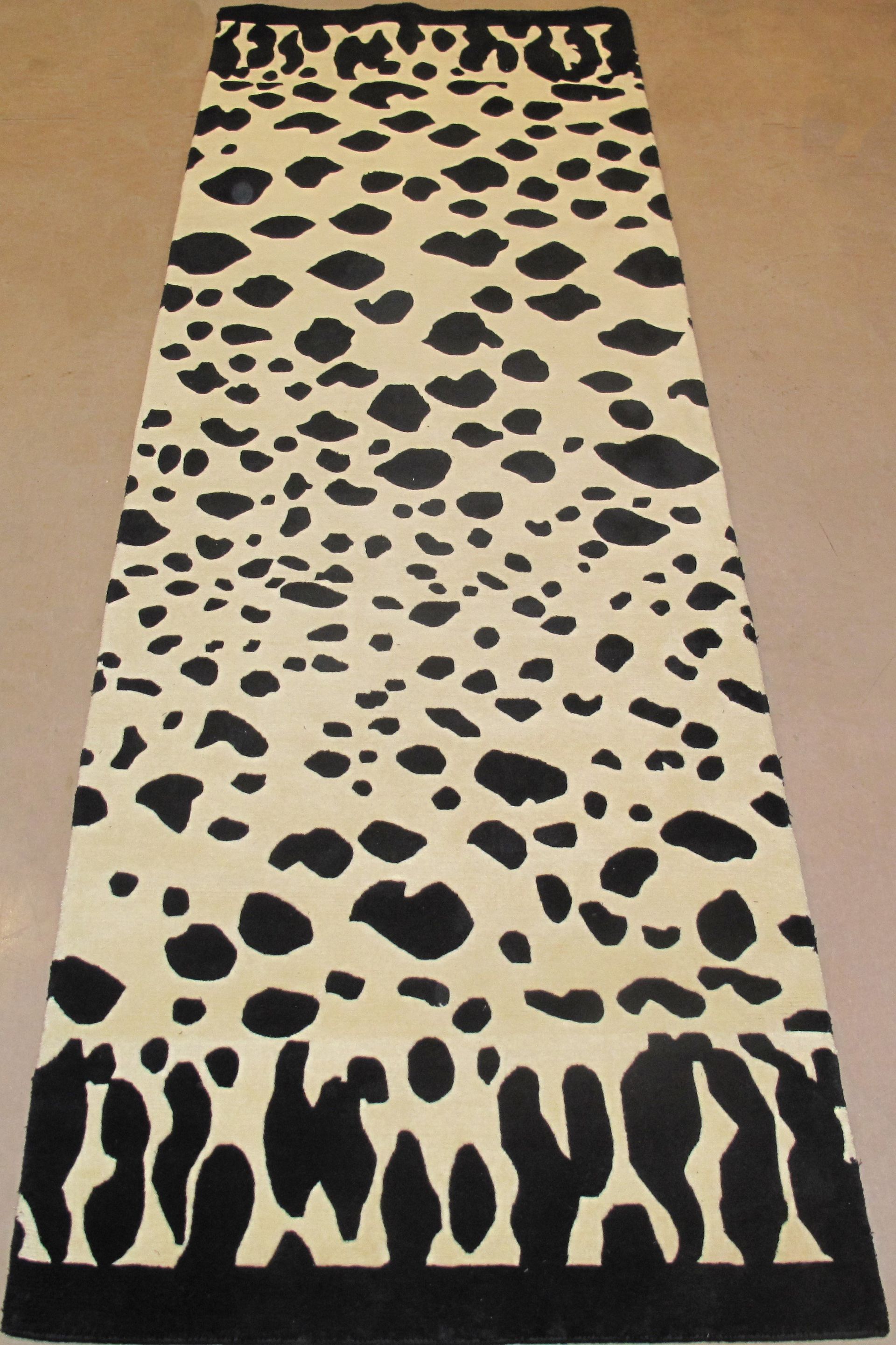 A dalmatian print rug with a black border