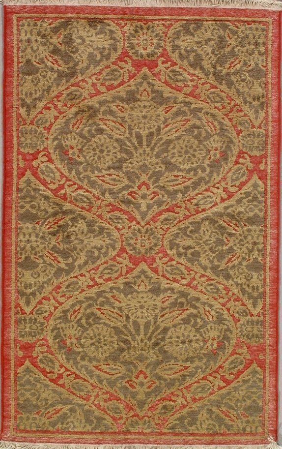 A rug with a floral pattern on it is hanging on a wall.