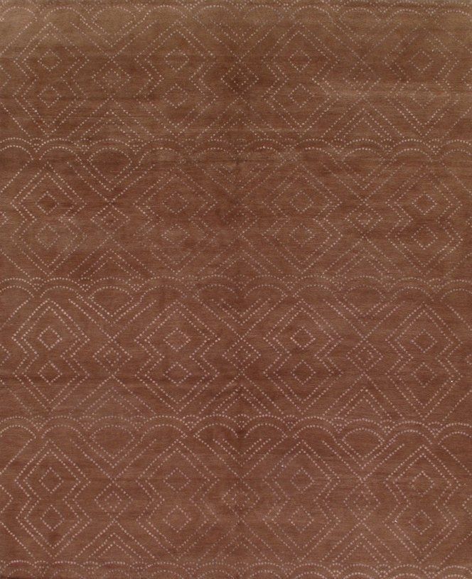 A close up of a brown rug with a geometric pattern on it.