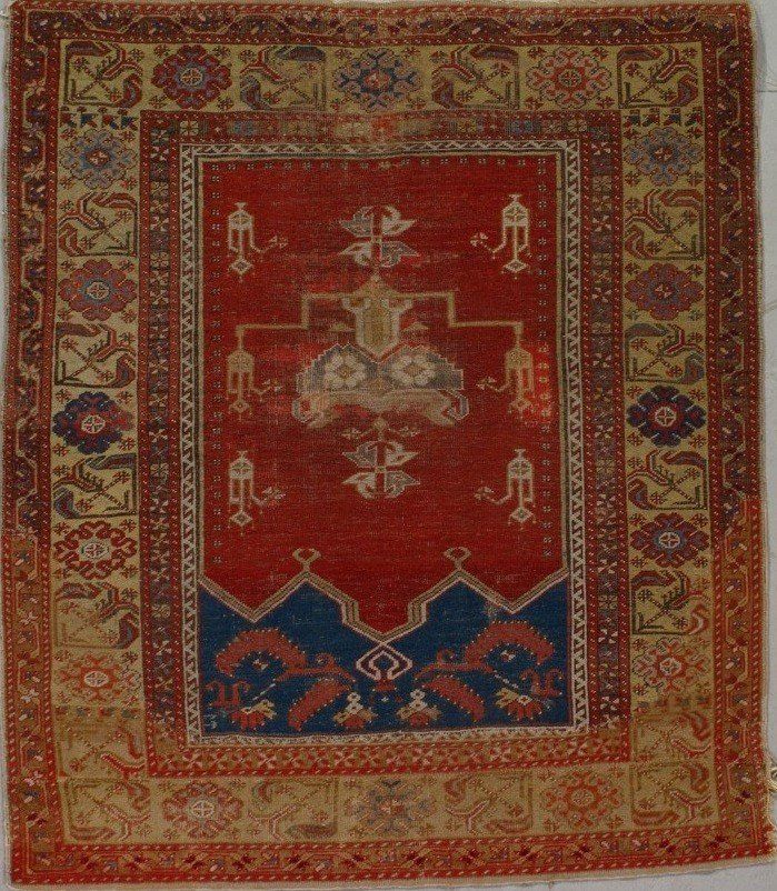A red and yellow rug with a blue border