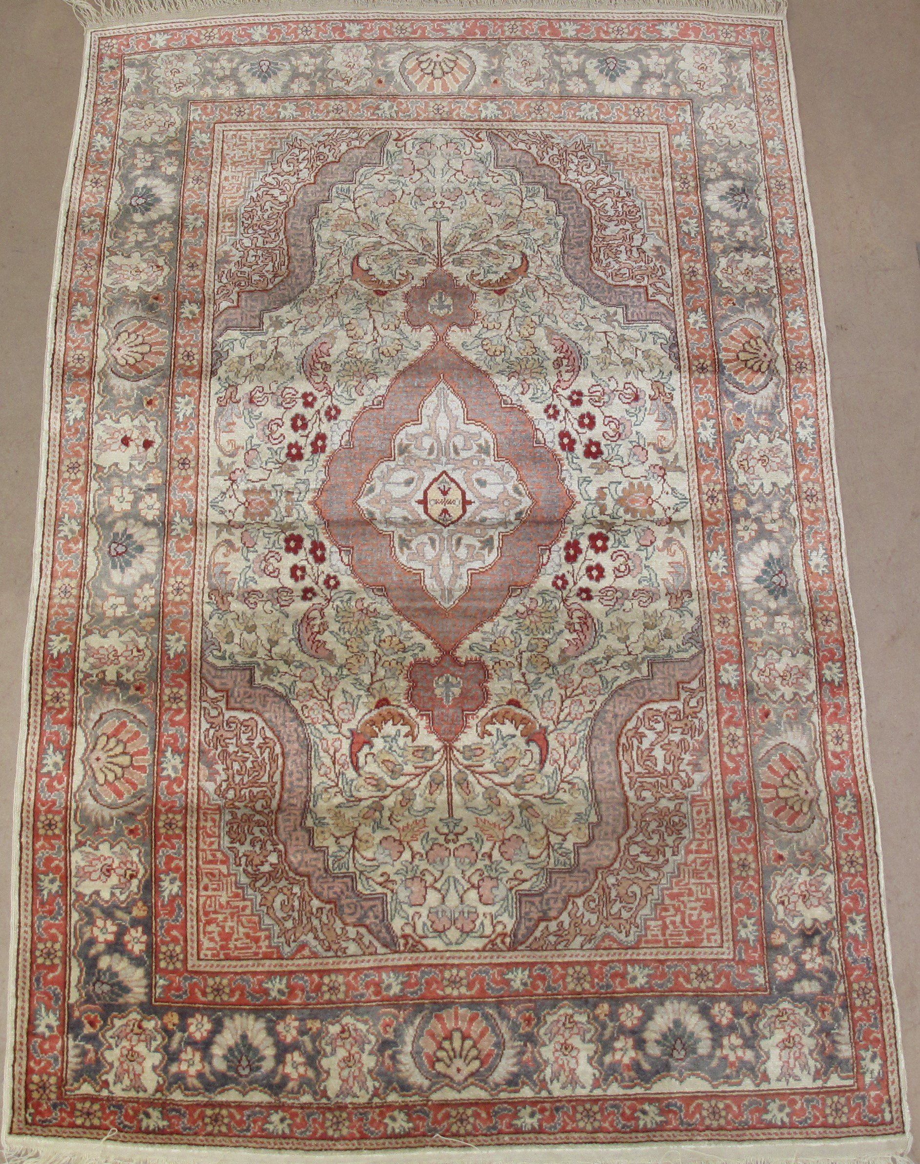 A rug with a floral pattern is sitting on a table.