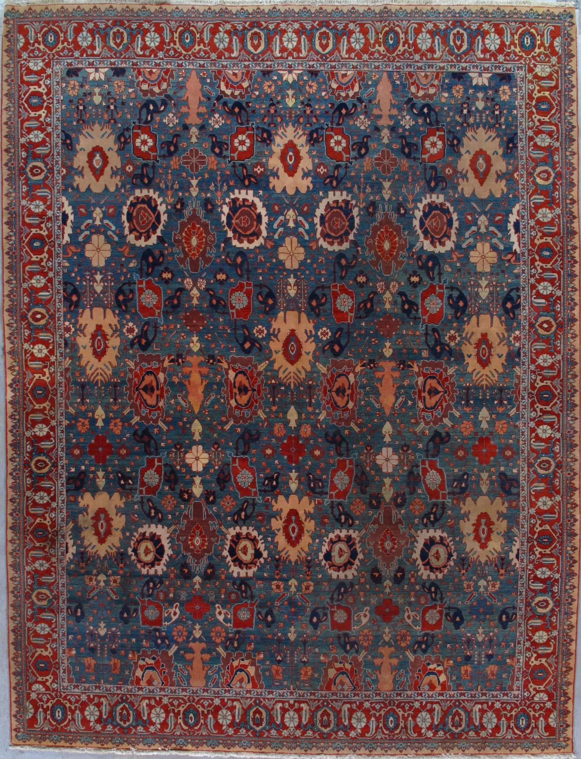 A blue and red rug with a floral pattern on it