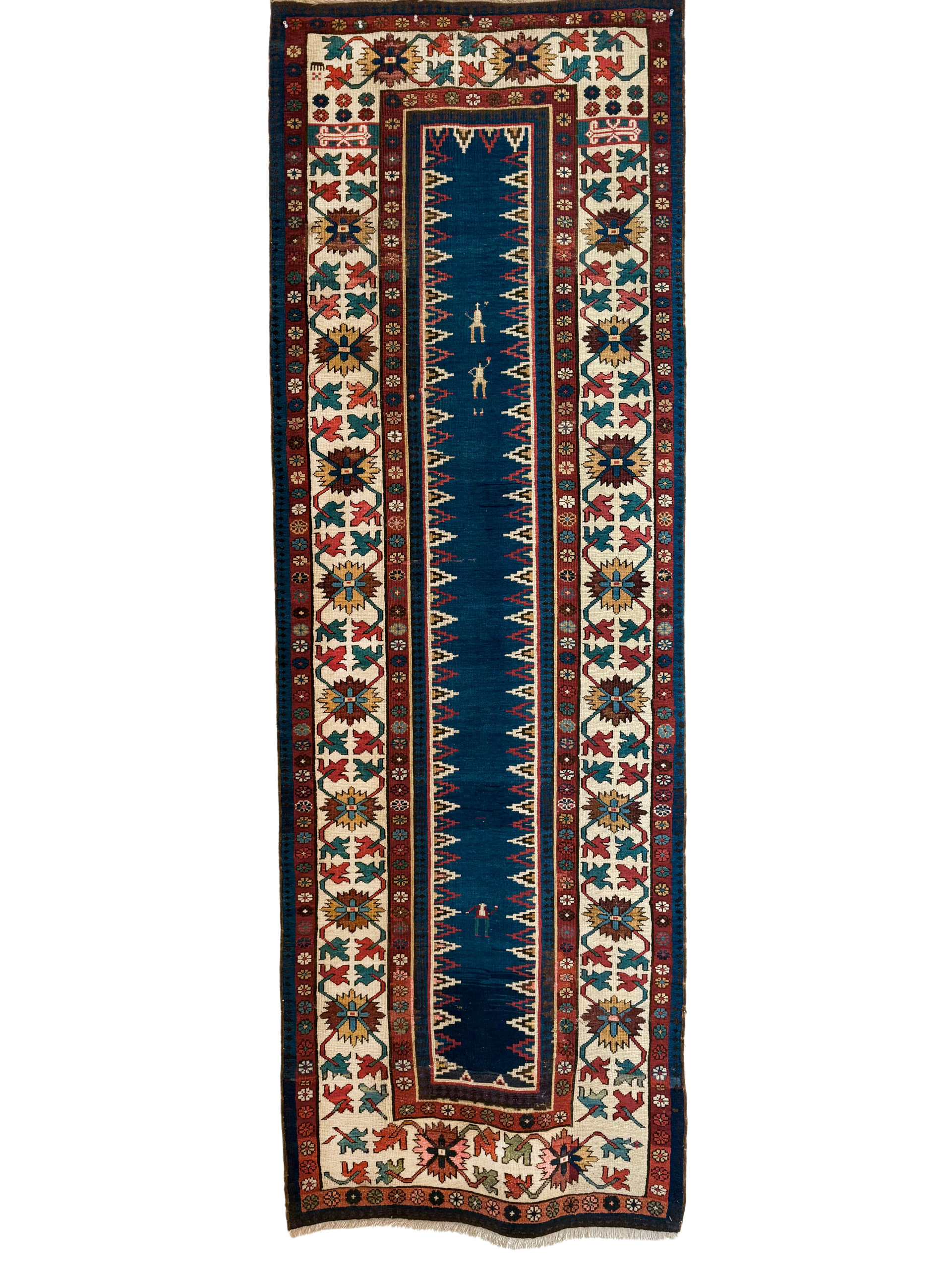 A rug with a blue border and a ruler on it