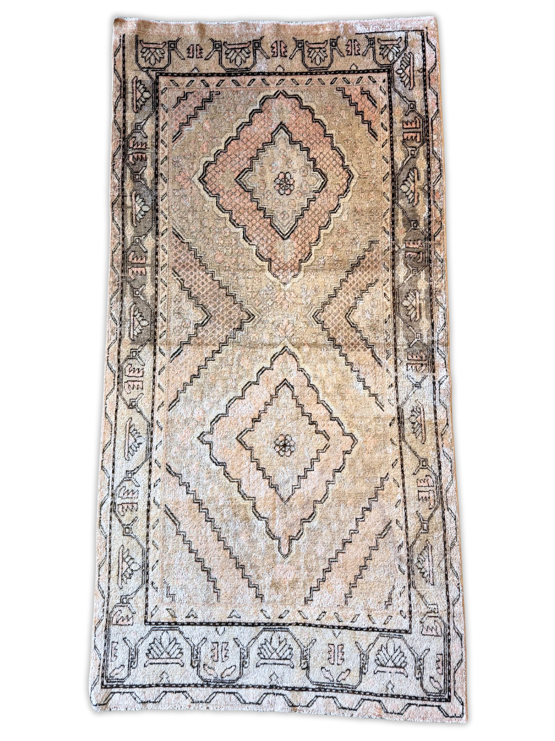 A rug with a geometric pattern on it is on a white background.