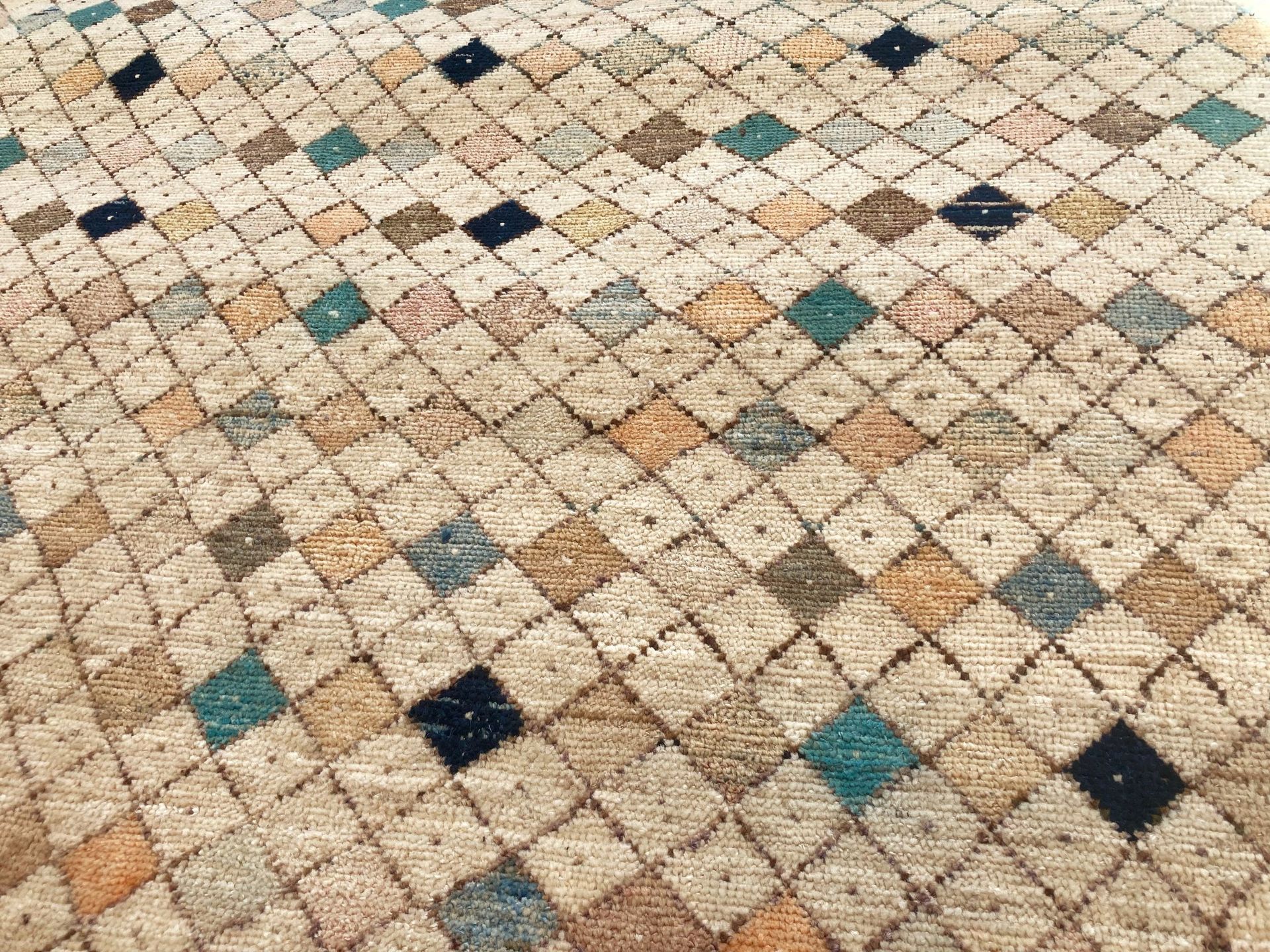 A close up of a rug with a pattern of squares on it.