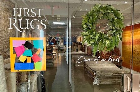 A store front with a sign that says first rugs