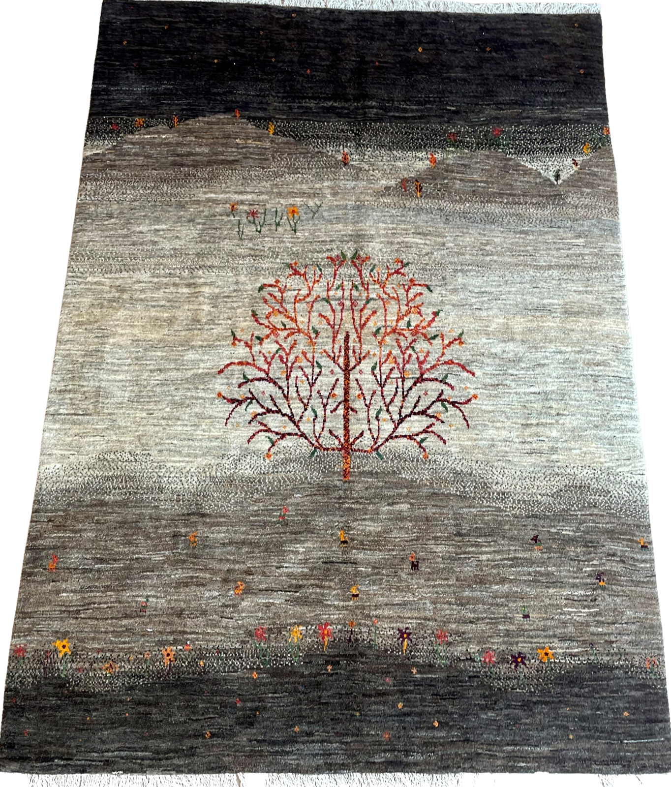 A rug with a tree on it on a white background.