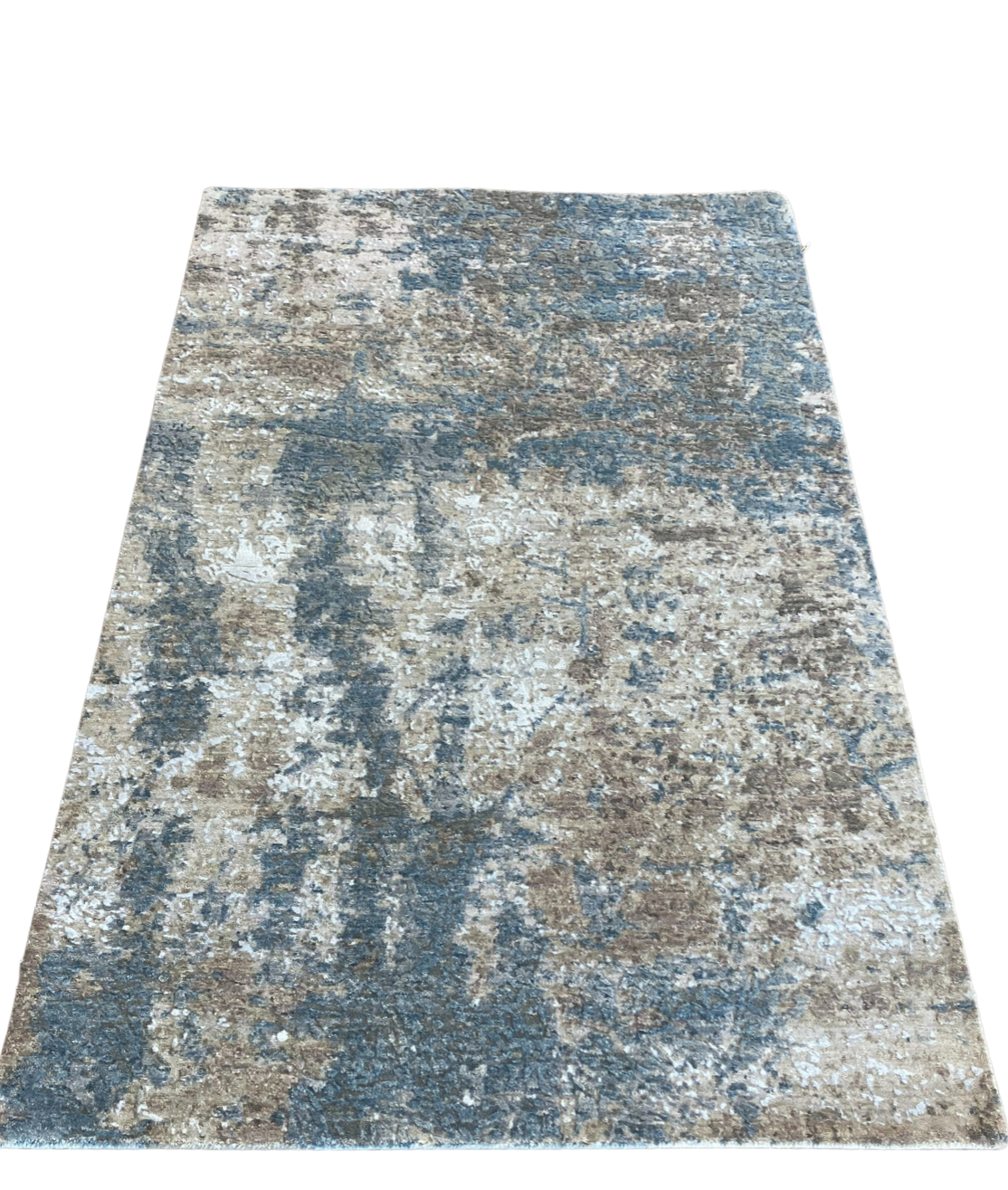 A blue and brown rug with a geometric pattern on a white background.