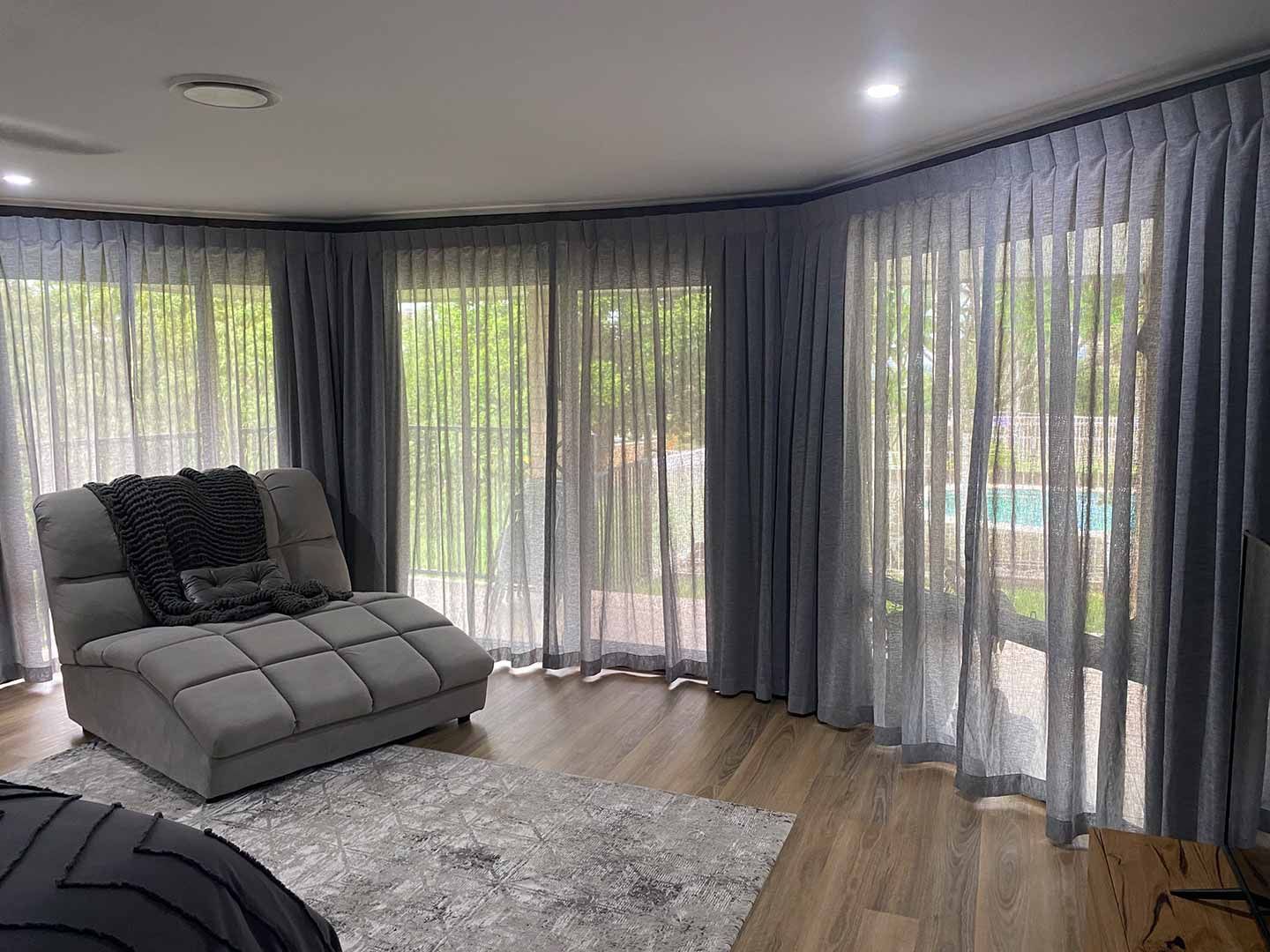 A Living Room With a Couch, Curtains and Sliding Glass Doors — Curtain Concepts in Kingscliff, NSW