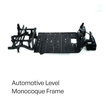 Black automotive monocoque frame, viewed from above. It is an open, box-like structure with various attachment points and a flat floor.
