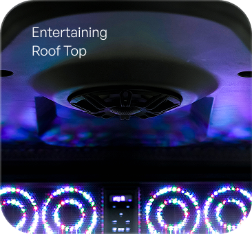 A dark entertainment setting with a rooftop view.  LED lights in purple and blue illuminate the space,  with decorative circular patterns and a central speaker.