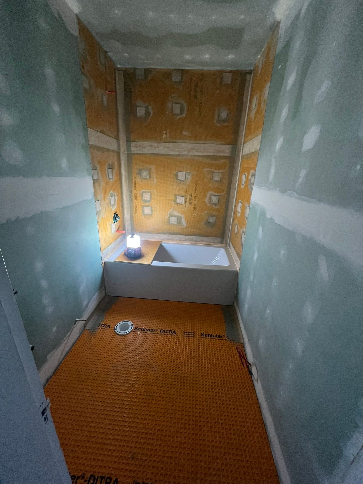 A bathroom under construction with a bathtub in it.