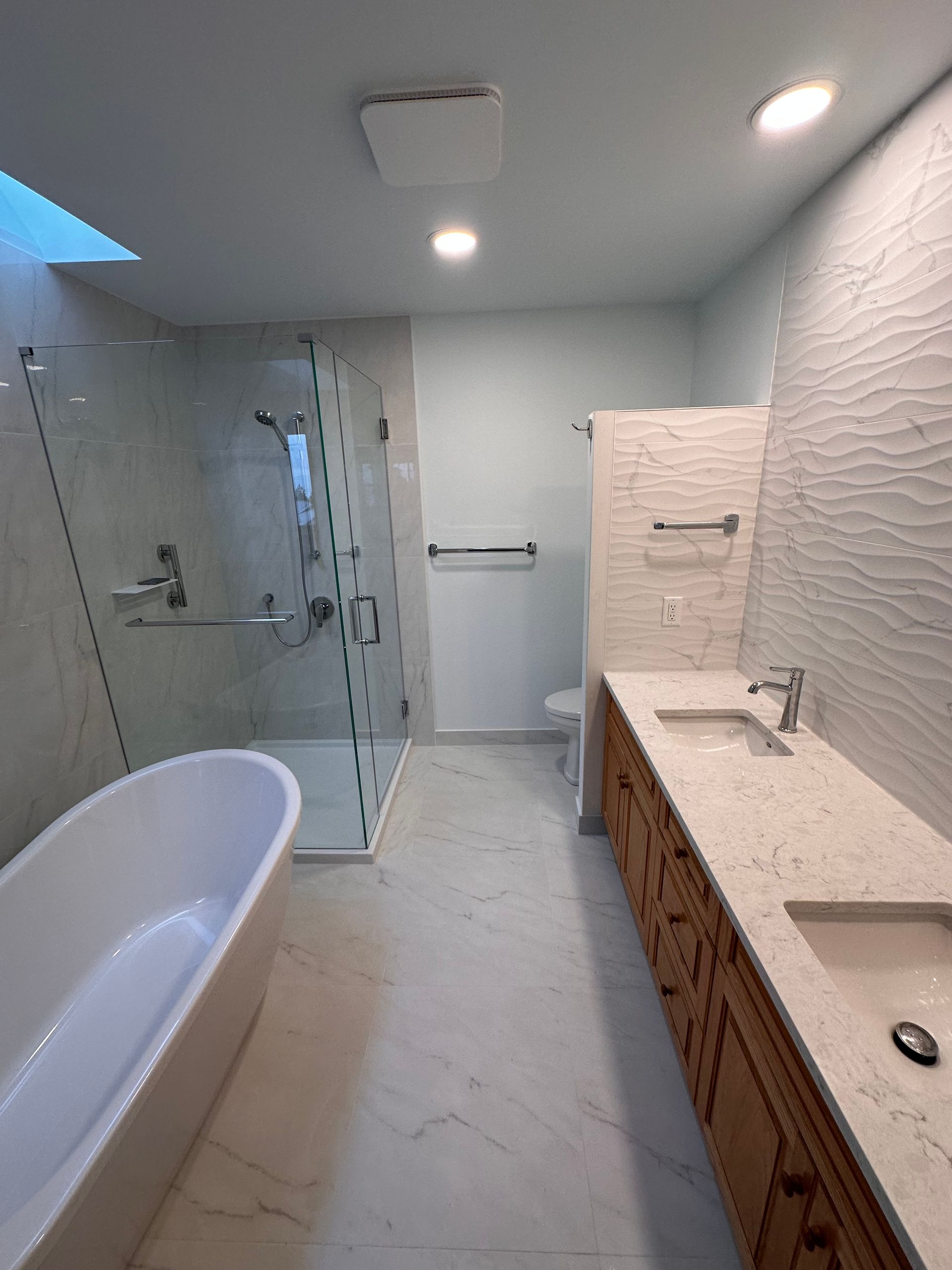 A bathroom with a bathtub , sink , and shower.